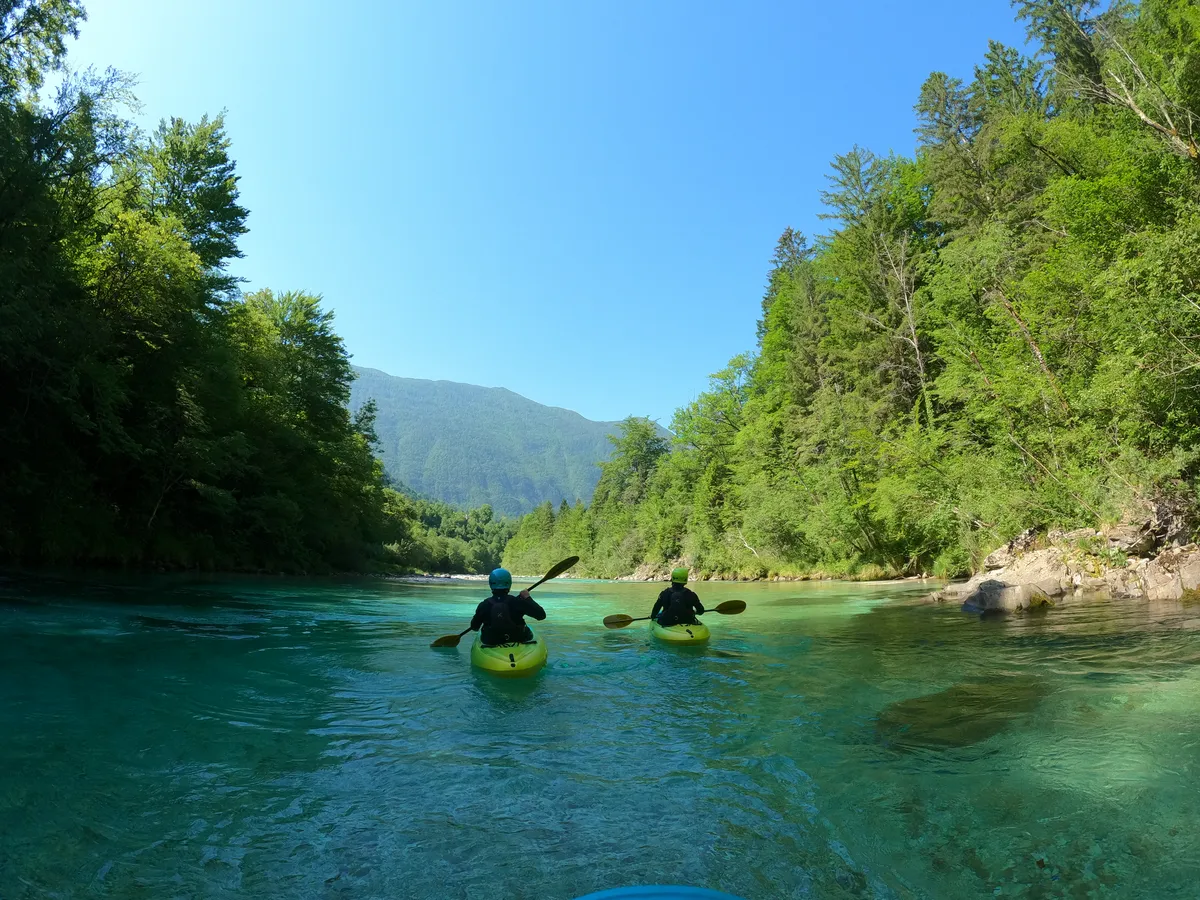 Two kayakers on the turquoise Soča